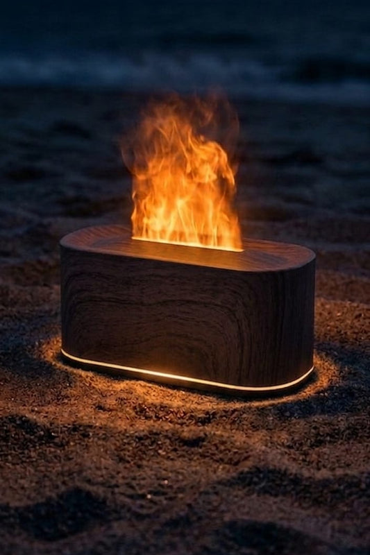Wooden fire Pit on a beach at night with flames burning brightly.