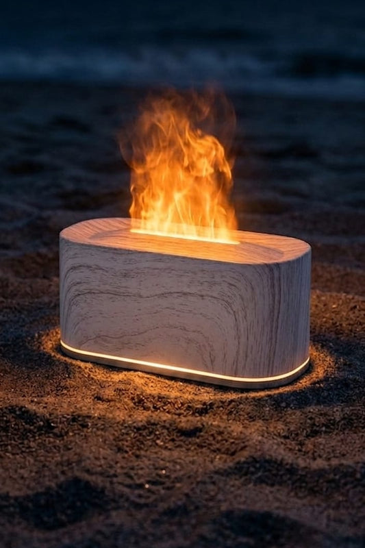 Fire pit on a beach at night with ocean waves in the background